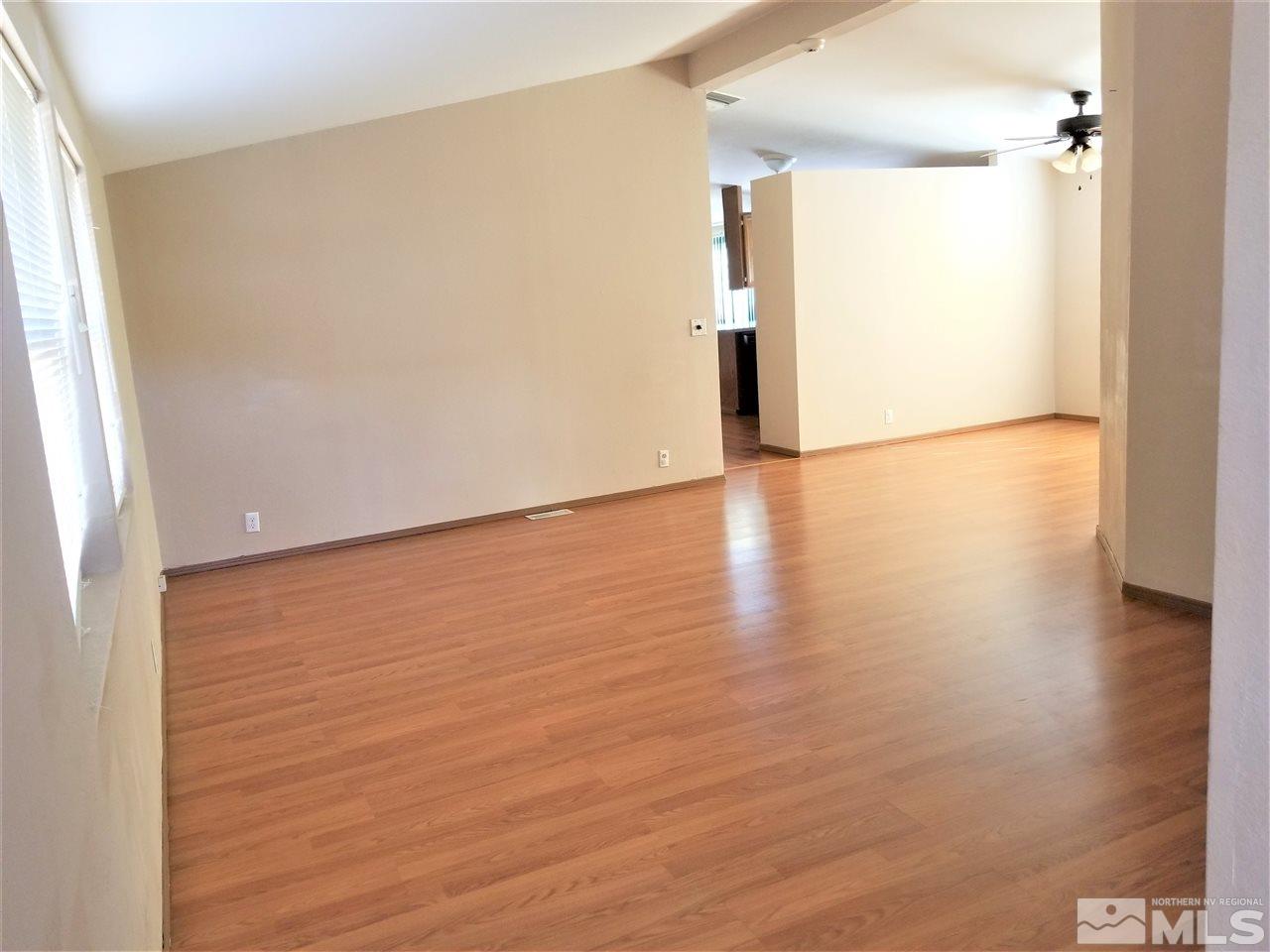 2750 Snapdragon Way Reno, NV 89512 - Photo 5 of 15 a view of an empty room with wooden floor and a window