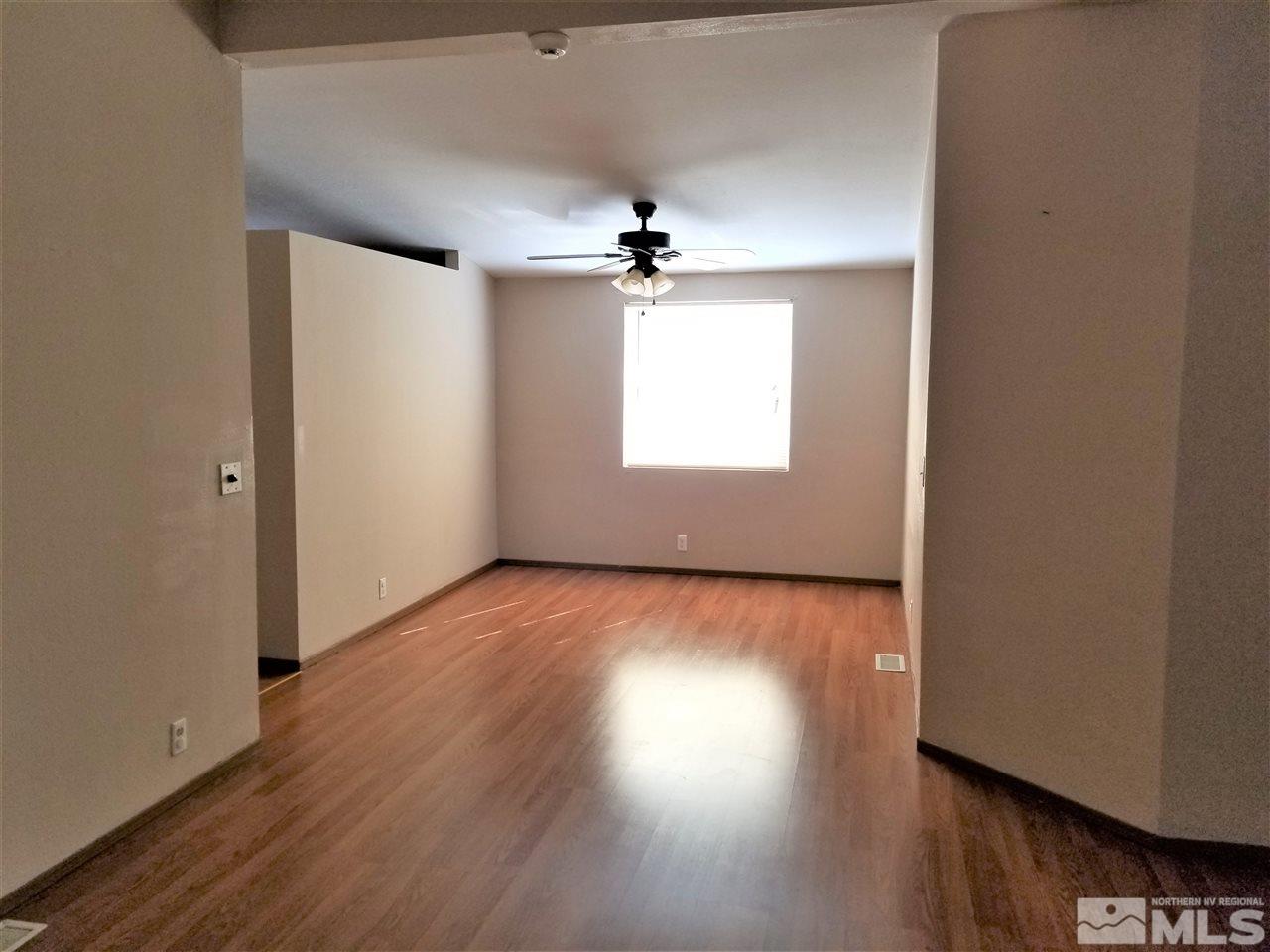 2750 Snapdragon Way Reno, NV 89512 - Photo 6 of 15 an empty room with wooden floor and windows