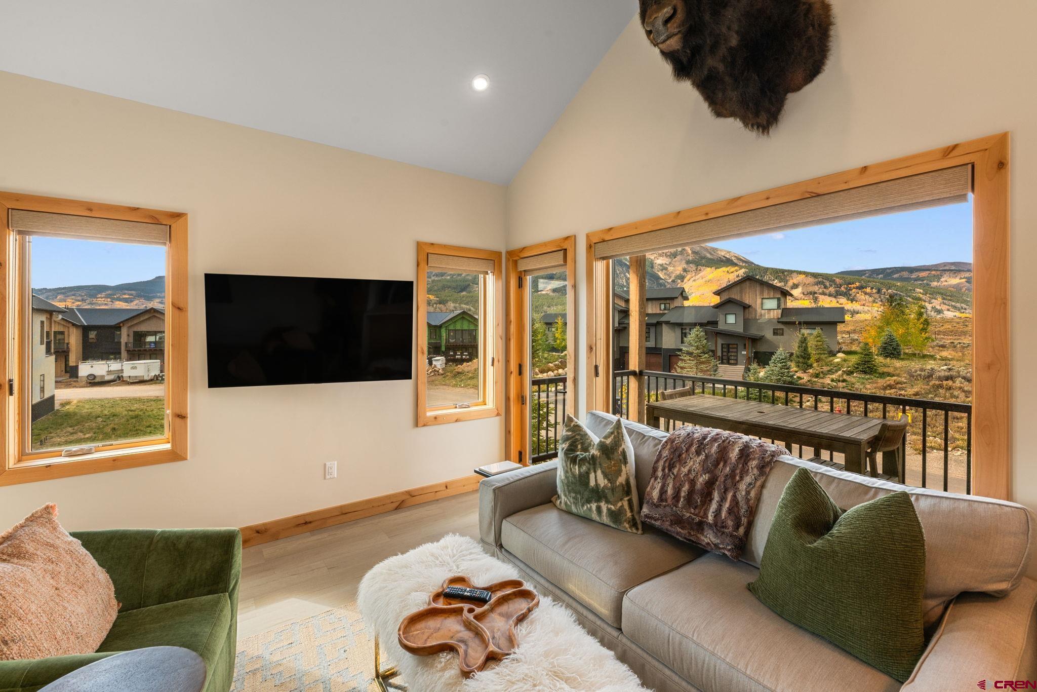 101 Elk Valley Road, Unit D Crested Butte, CO 81224 - Photo 13 of 37 a living room with furniture tv and a large window