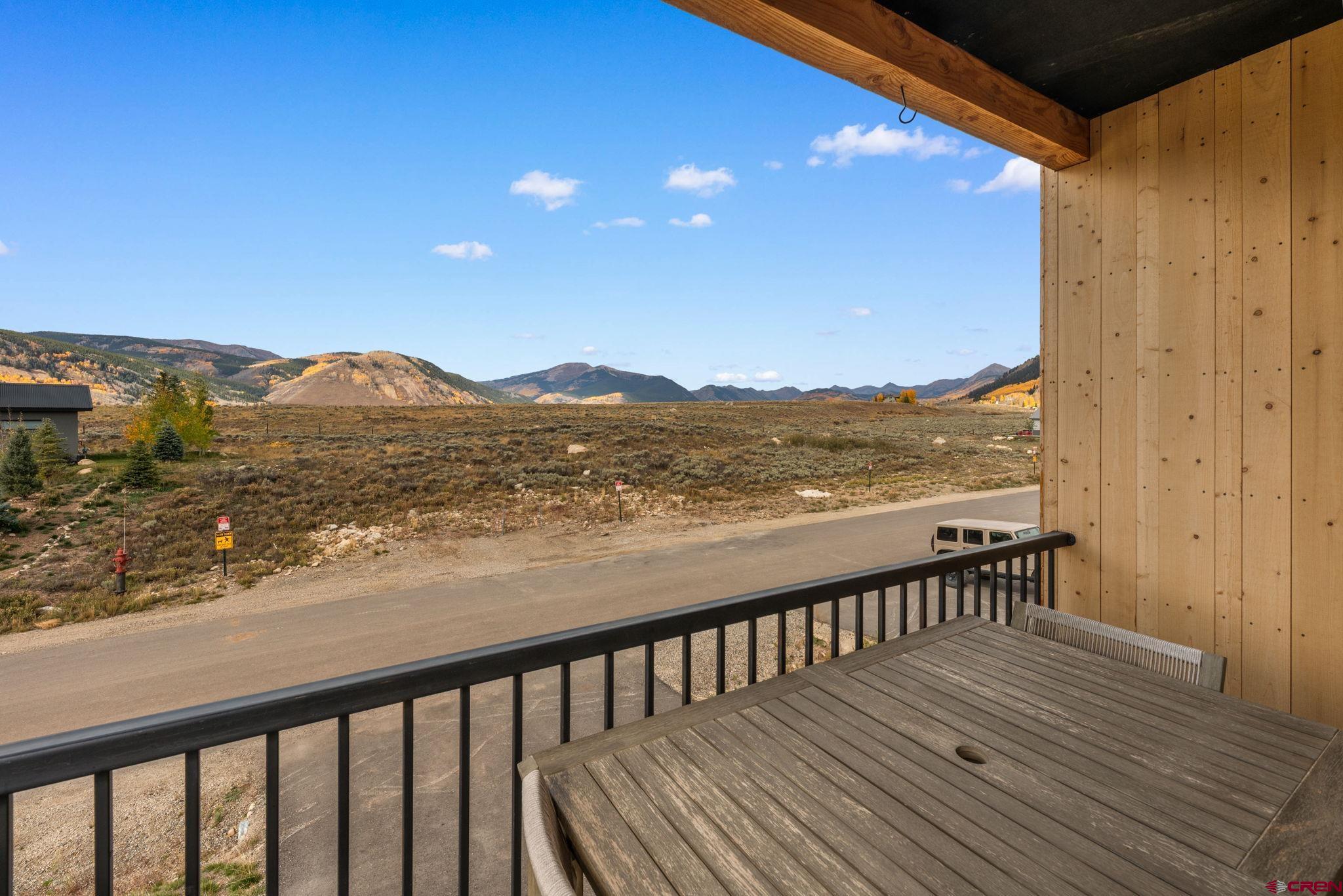101 Elk Valley Road, Unit D Crested Butte, CO 81224 - Photo 15 of 37 a view of balcony with wooden floor and mountain view