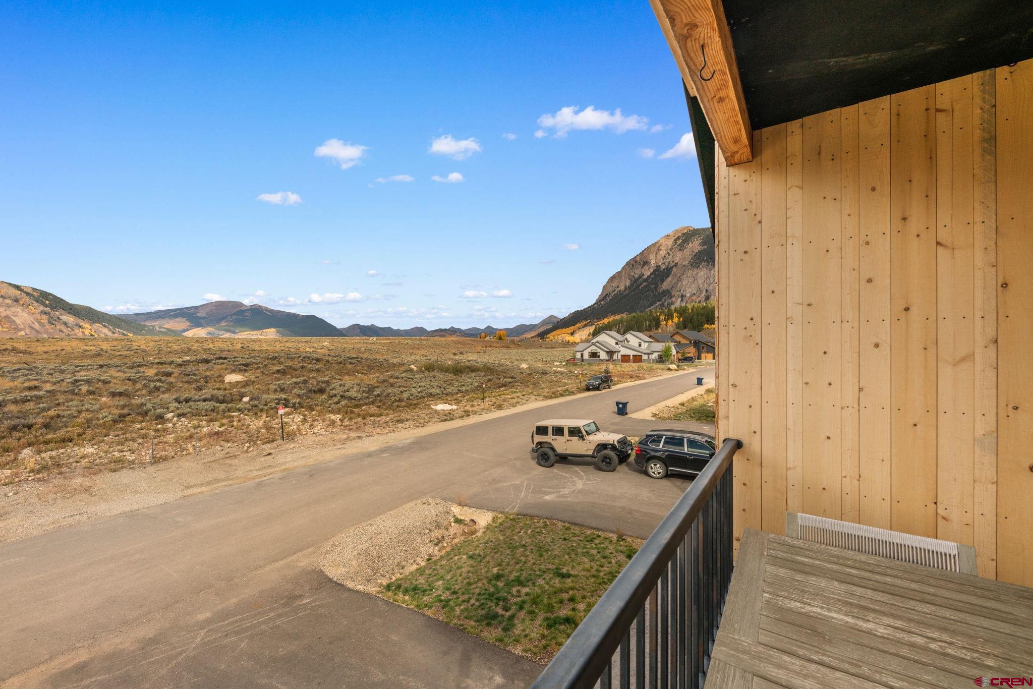 101 Elk Valley Road, Unit D Crested Butte, CO 81224 - Photo 17 of 37 a view of a terrace with wooden floor and a ocean view