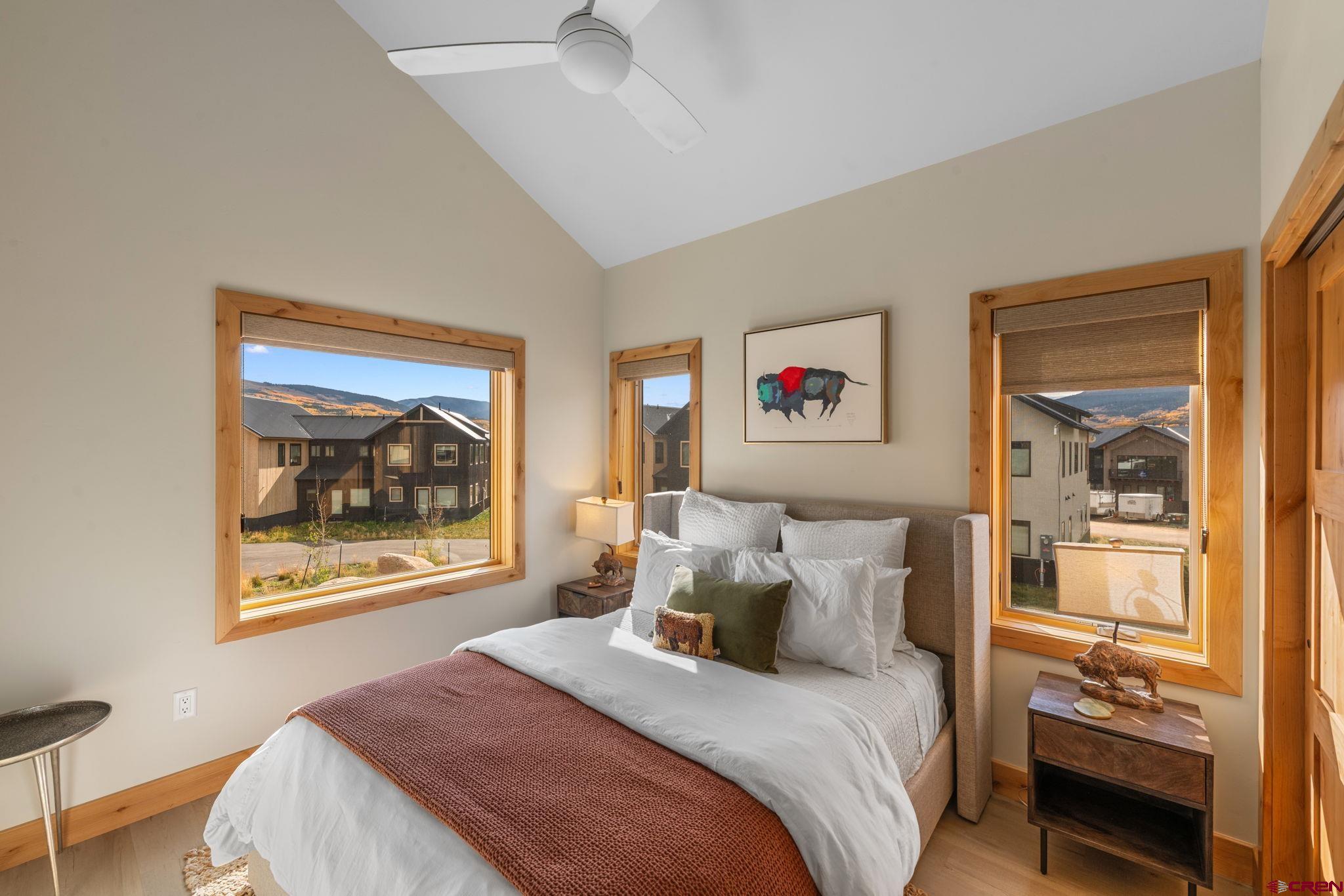 101 Elk Valley Road, Unit D Crested Butte, CO 81224 - Photo 28 of 37 a bedroom with a bed and a painting on the wall