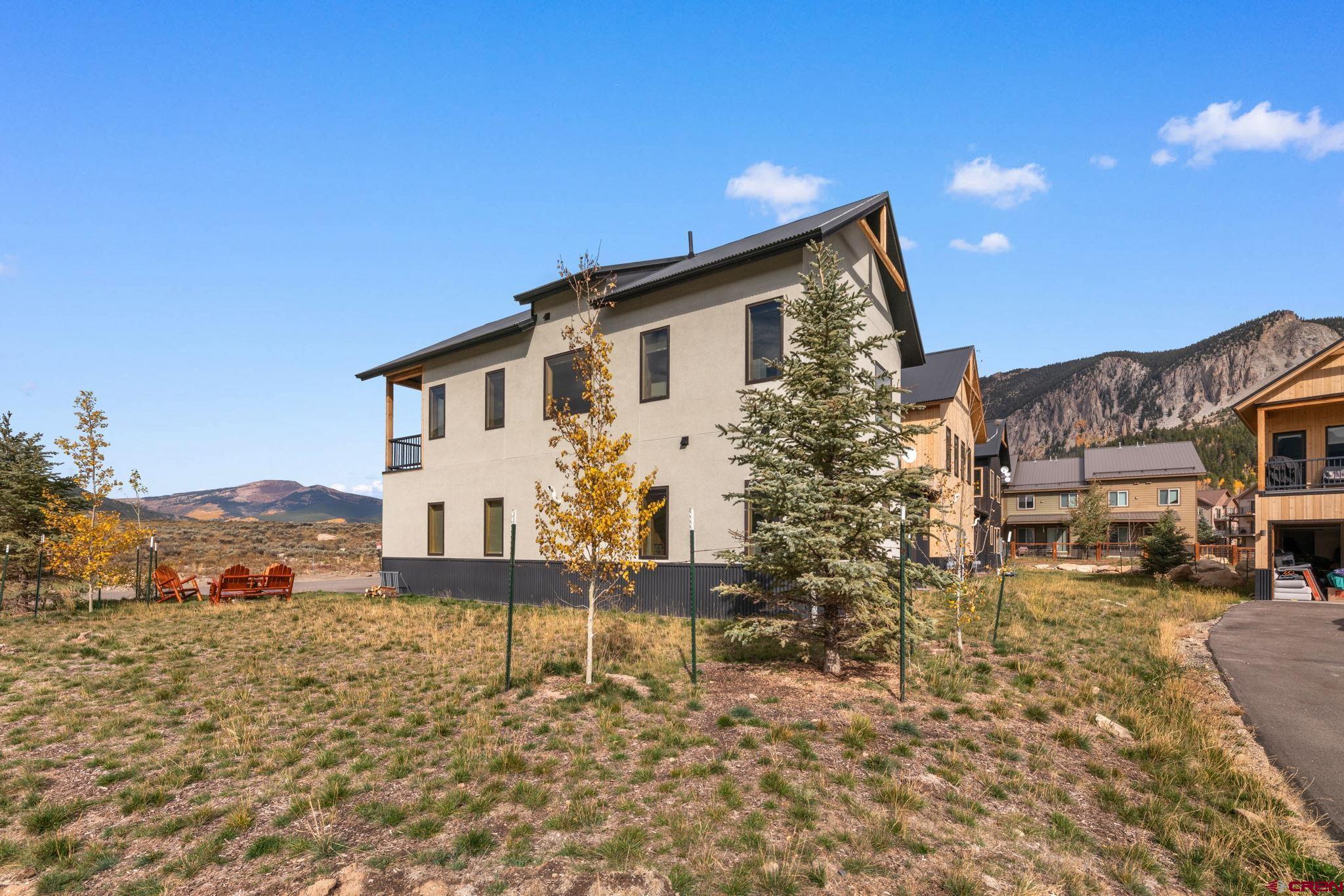 101 Elk Valley Road, Unit D Crested Butte, CO 81224 - Photo 35 of 37 a view of a house with a yard