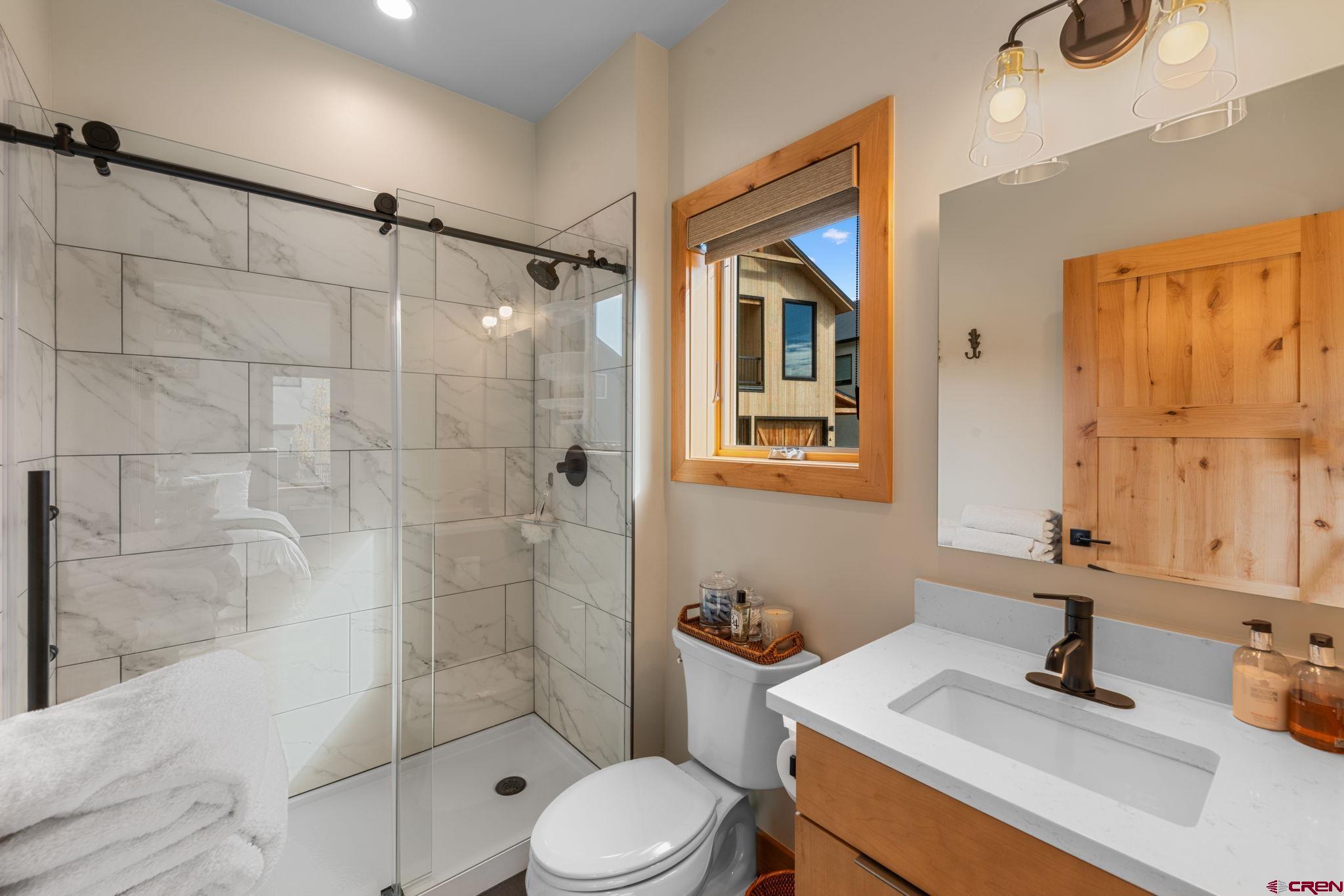 101 Elk Valley Road, Unit D Crested Butte, CO 81224 - Photo 8 of 37 a bathroom with a sink toilet and shower