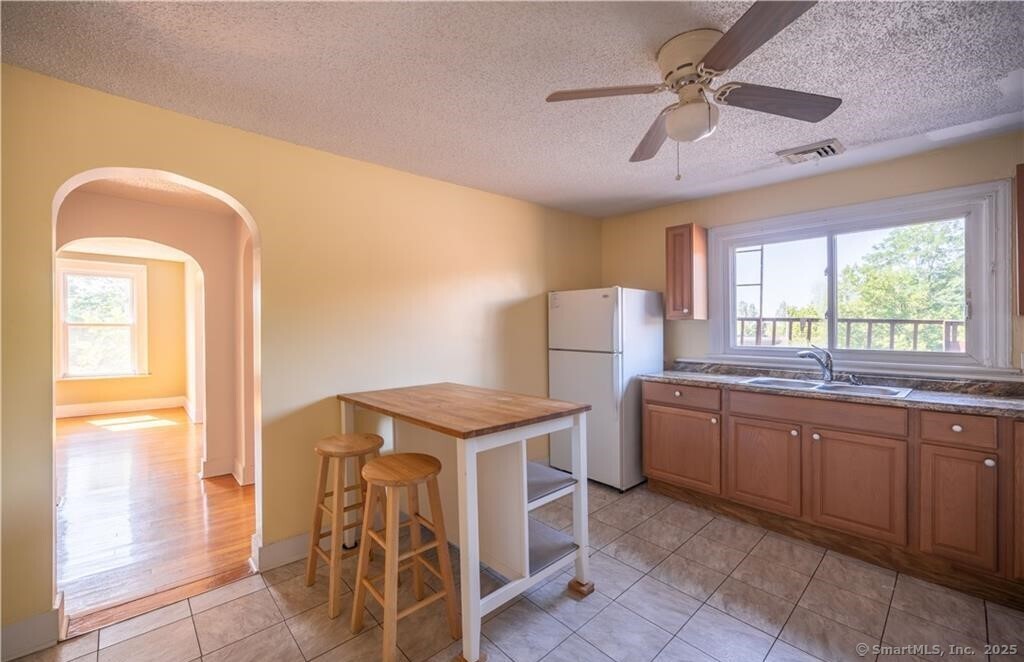 a kitchen with a sink a stove and chairs