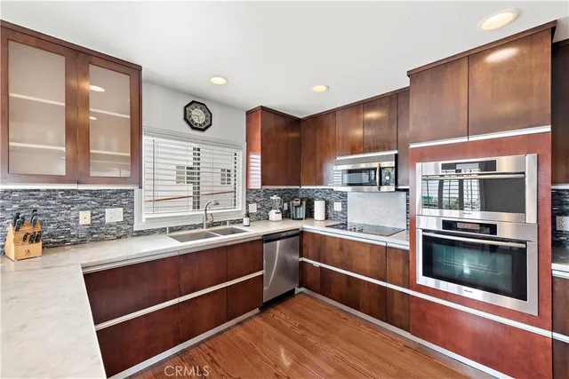 a kitchen with stainless steel appliances kitchen island granite countertop a sink and cabinets