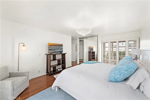 a spacious bedroom with a bed and a large window