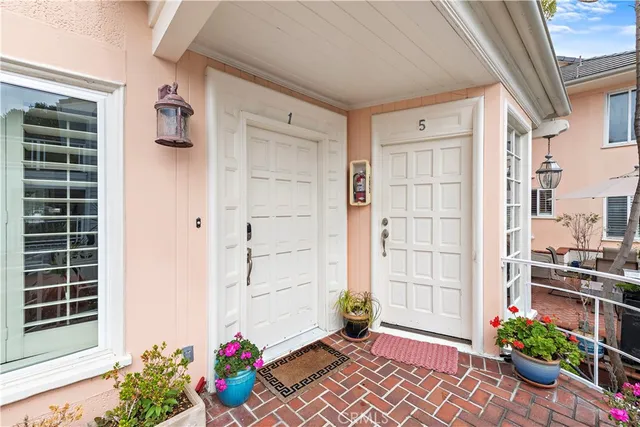 a front view of a house with a potted plant