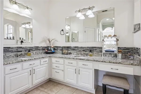 a bathroom with a sink vanity granite and a mirror