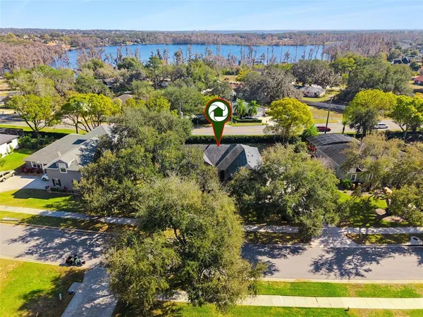 an aerial view of a house with a yard