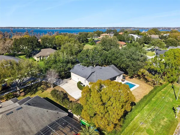 an aerial view of a house with a yard