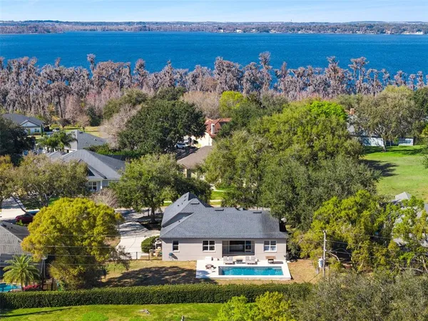 an aerial view of a house with a lake view