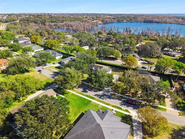 an aerial view of a house with a yard basket ball court and outdoor seating