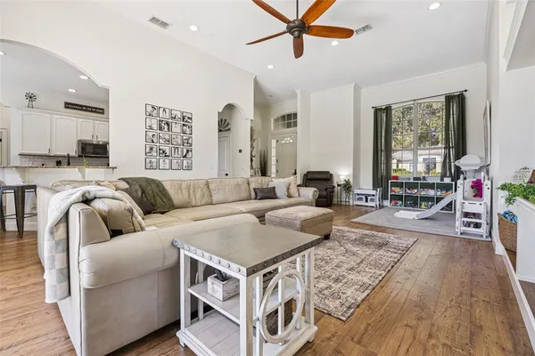 a living room with furniture and a wooden floor