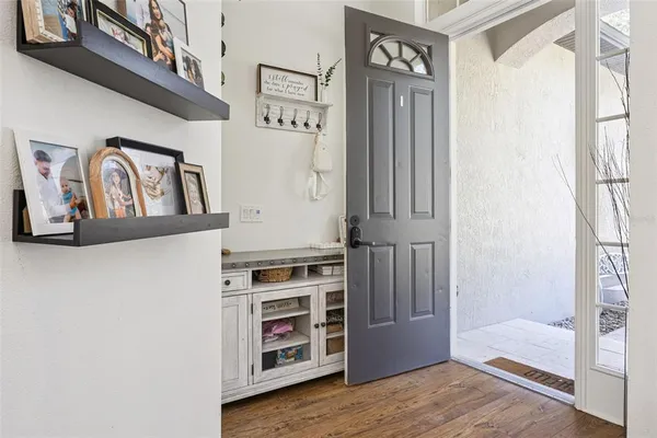 a view of a hallway with wooden floor and closet