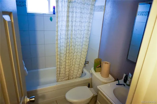 a bathroom with a toilet and shower