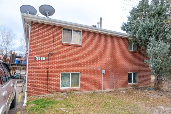 a front view of a house with plants