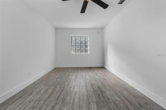 wooden floor in an empty room with a window