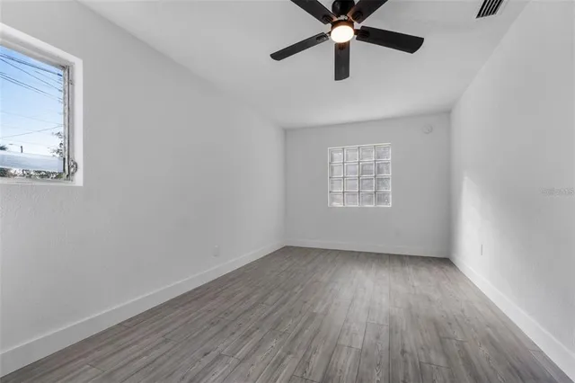 wooden floor in an empty room with a window