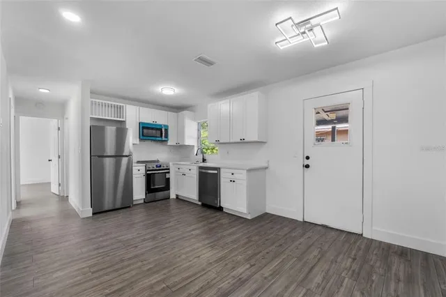 a kitchen with stainless steel appliances a refrigerator and a oven