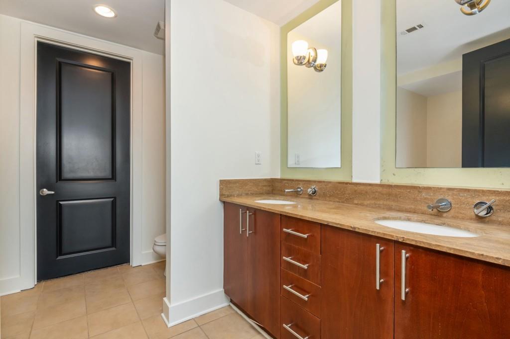 4561 Olde Perimeter Way, Unit 1701 Atlanta, GA 30346 - Photo 25 of 64 a bathroom with a sink and a mirror
