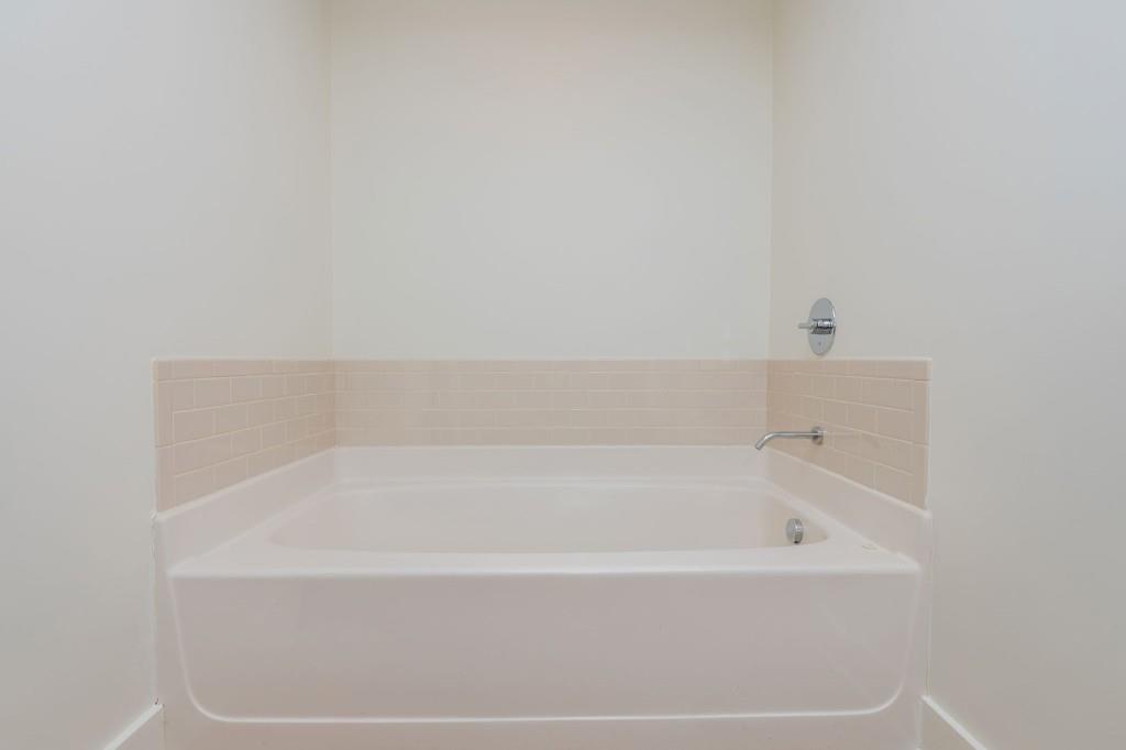 4561 Olde Perimeter Way, Unit 1701 Atlanta, GA 30346 - Photo 26 of 64 a white bath tub sitting next to a white sink