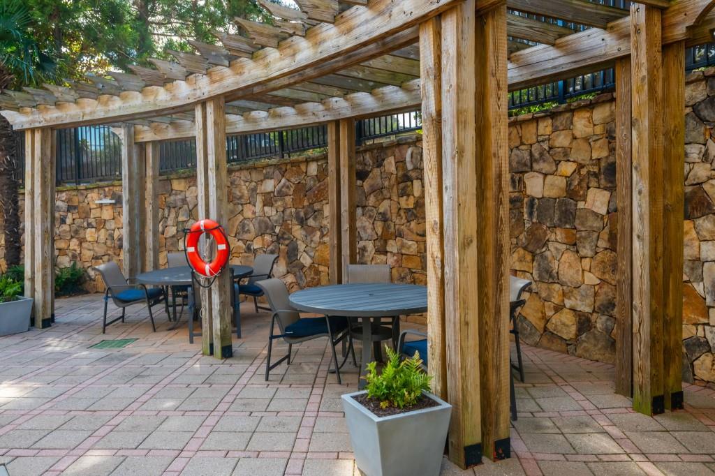 4561 Olde Perimeter Way, Unit 1701 Atlanta, GA 30346 - Photo 44 of 64 a view of a tables and chairs in patio with a potted plant