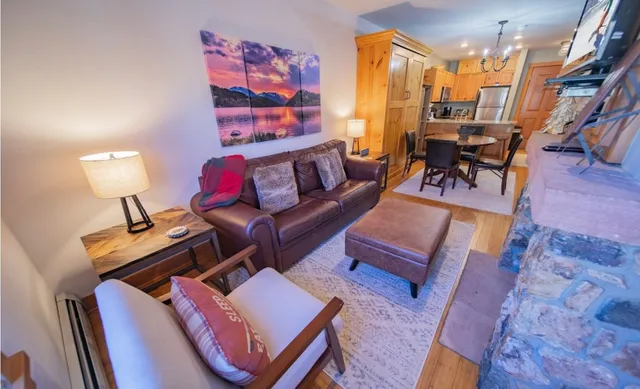 a living room with furniture and a lamp