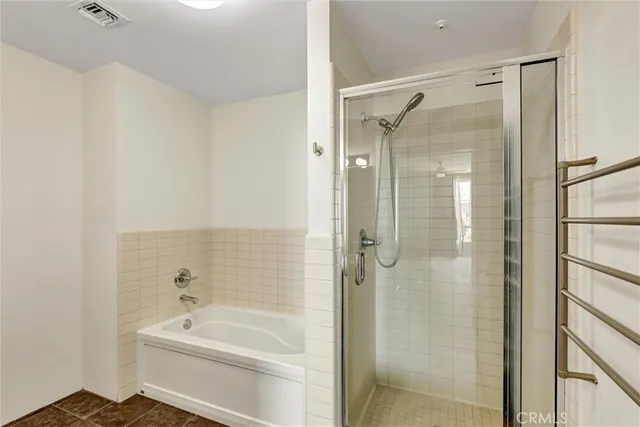 a bathroom with a bathtub shower sink mirror and toilet