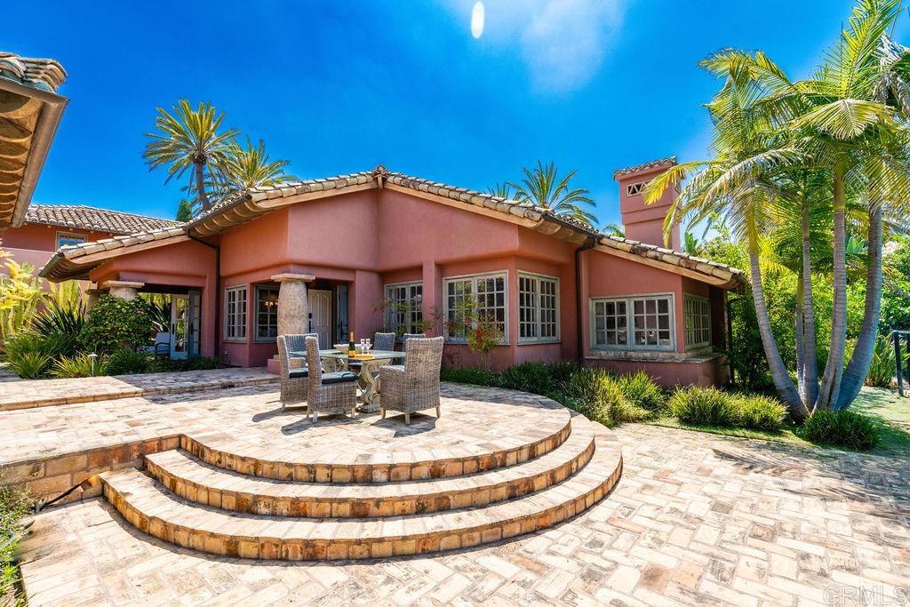 a view of a house with backyard porch and sitting area