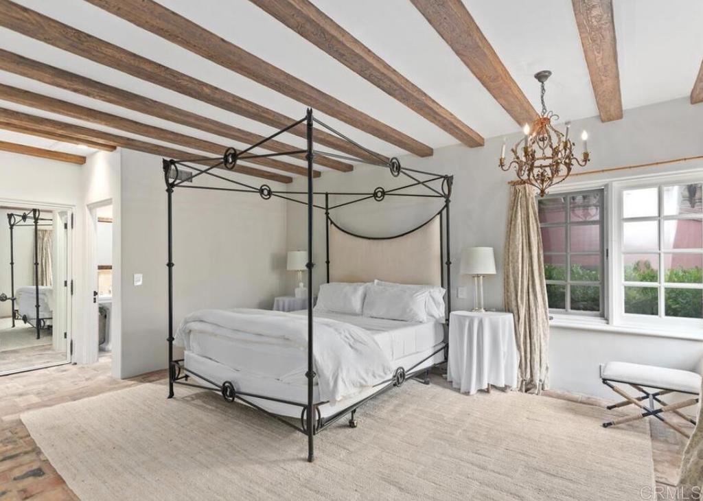 17116 Paseo Hermosa Rancho Santa Fe, CA 92067 - Photo 11 of 28 a bedroom with a bed and a chandelier