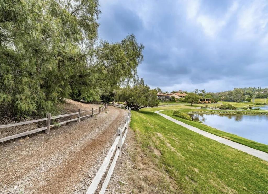 17116 Paseo Hermosa Rancho Santa Fe, CA 92067 - Photo 25 of 28 a view of a lake with a building in the background