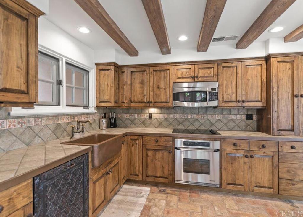 17116 Paseo Hermosa Rancho Santa Fe, CA 92067 - Photo 7 of 28 a kitchen with stainless steel appliances granite countertop a sink and a stove