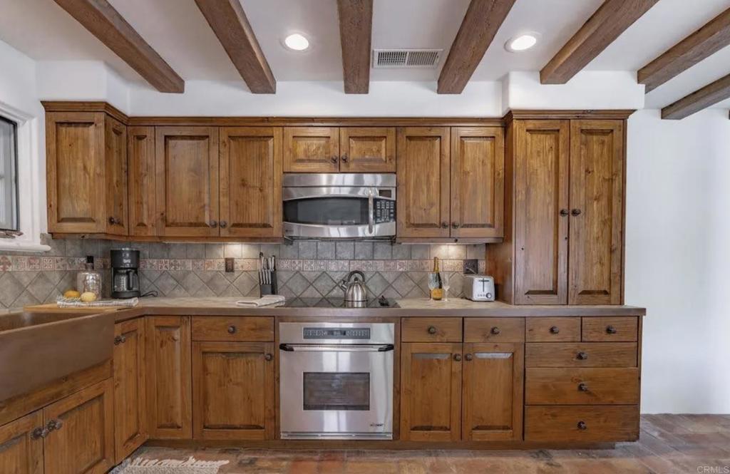 17116 Paseo Hermosa Rancho Santa Fe, CA 92067 - Photo 9 of 28 a kitchen with stainless steel appliances granite countertop a sink a stove and cabinets