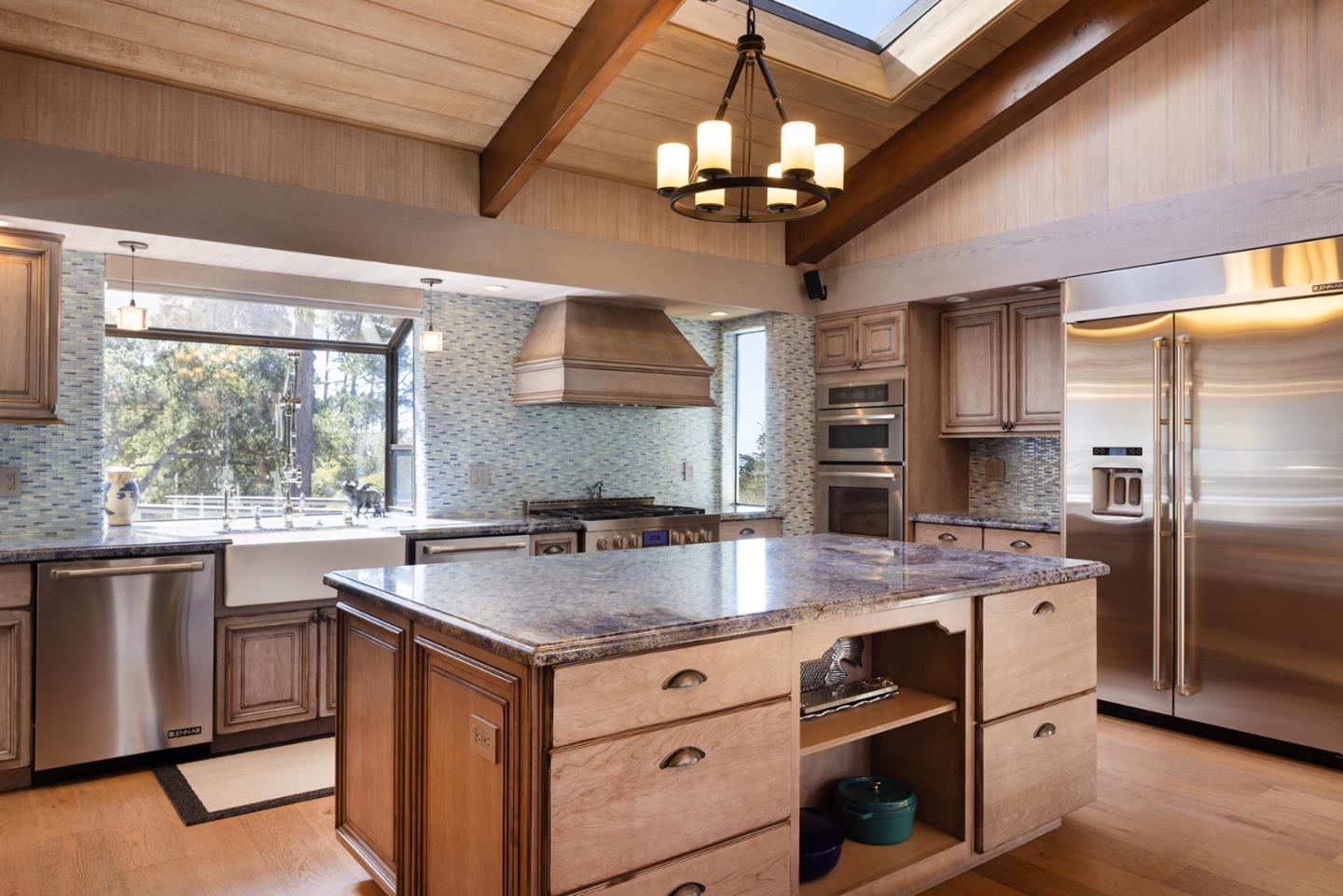3893 Ronda Road Pebble Beach, CA 93953 - Photo 14 of 48 a kitchen with a center island a counter space cabinets and stainless steel appliances