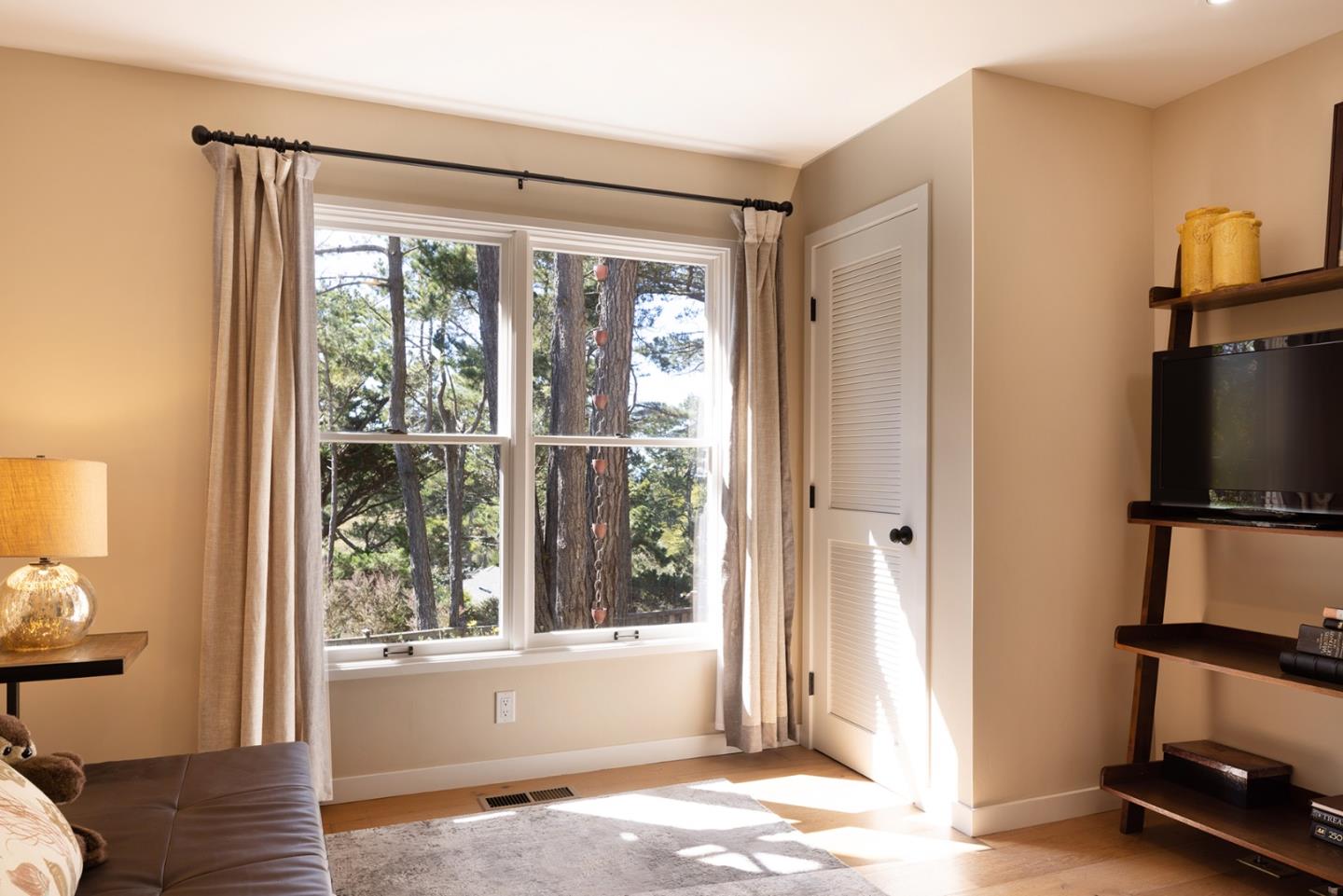 3893 Ronda Road Pebble Beach, CA 93953 - Photo 35 of 48 a view of a livingroom with wooden floor and a flat screen tv