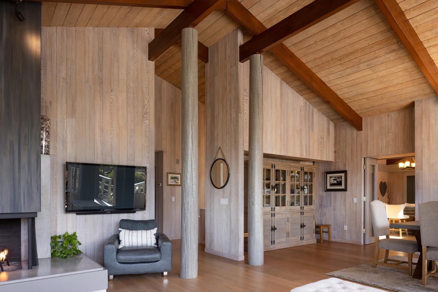 3893 Ronda Road Pebble Beach, CA 93953 - Photo 9 of 48 a living room with furniture a flat screen tv and a fireplace