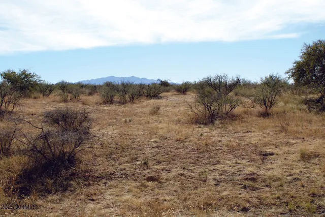 a view of mountain with sunset in background