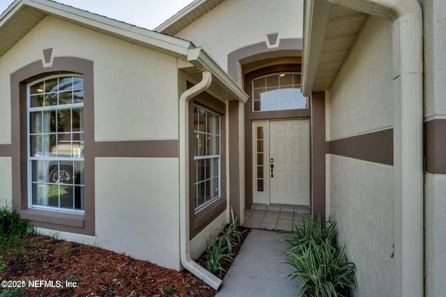 a front view of a house with a blue gate
