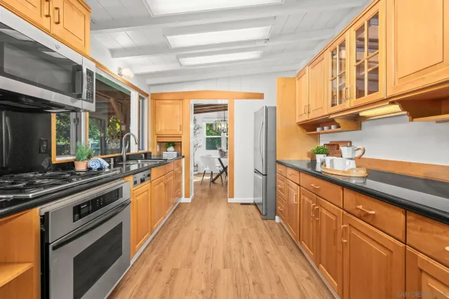 a kitchen with stainless steel appliances a sink and cabinets