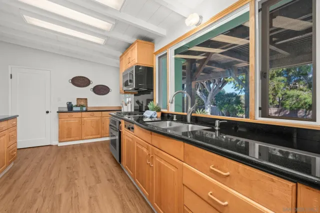 a kitchen with wooden floors and a sink