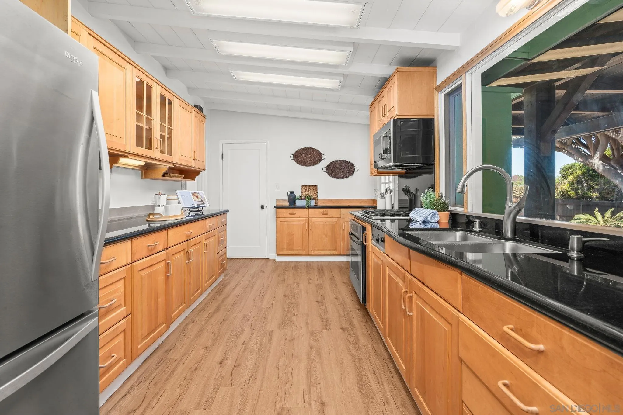 1395 Summit Avenue Cardiff, CA 92007 - Photo 14 of 47 a large kitchen with stainless steel appliances granite countertop a sink and wooden cabinets