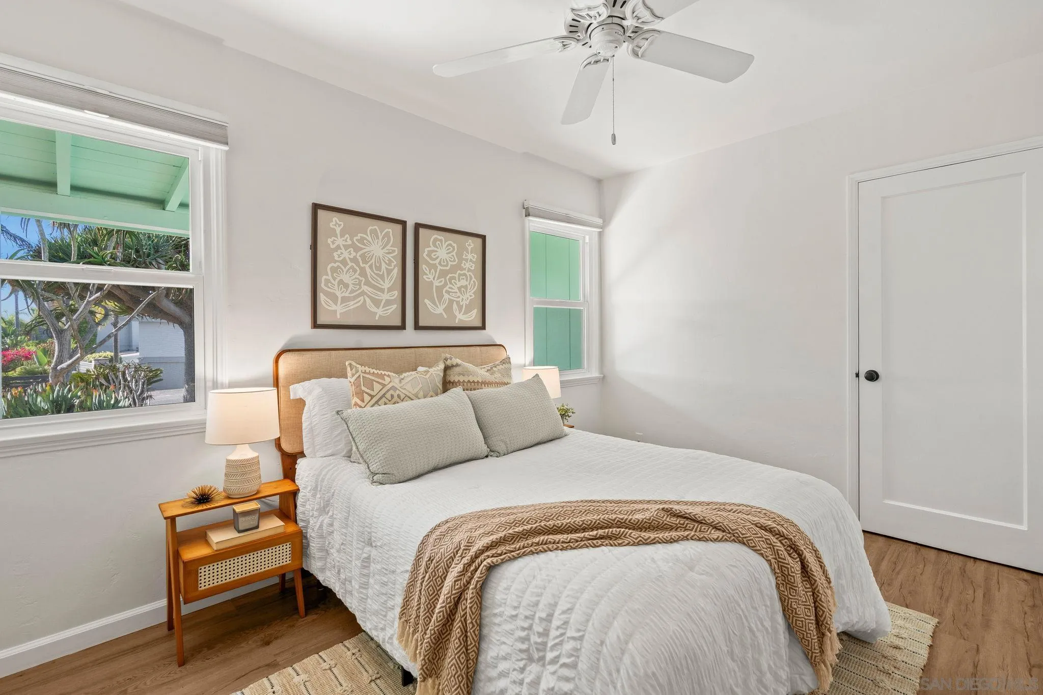 1395 Summit Avenue Cardiff, CA 92007 - Photo 16 of 47 a bedroom with a bed and a chandelier