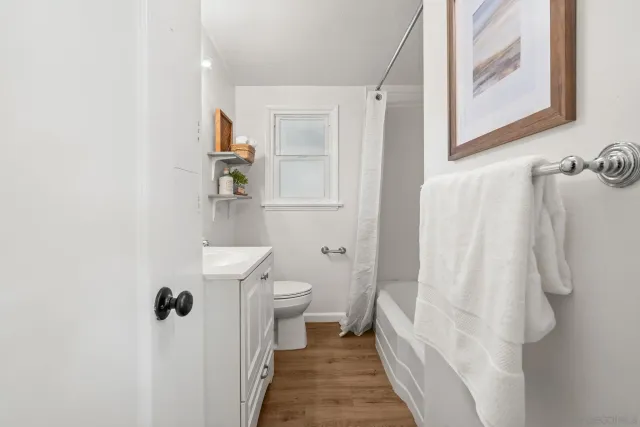 a bathroom with a sink a toilet and shower curtain
