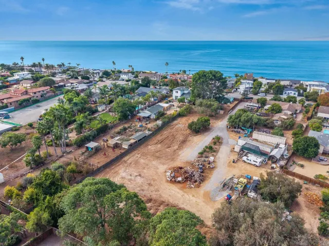 an aerial view of a city with ocean view