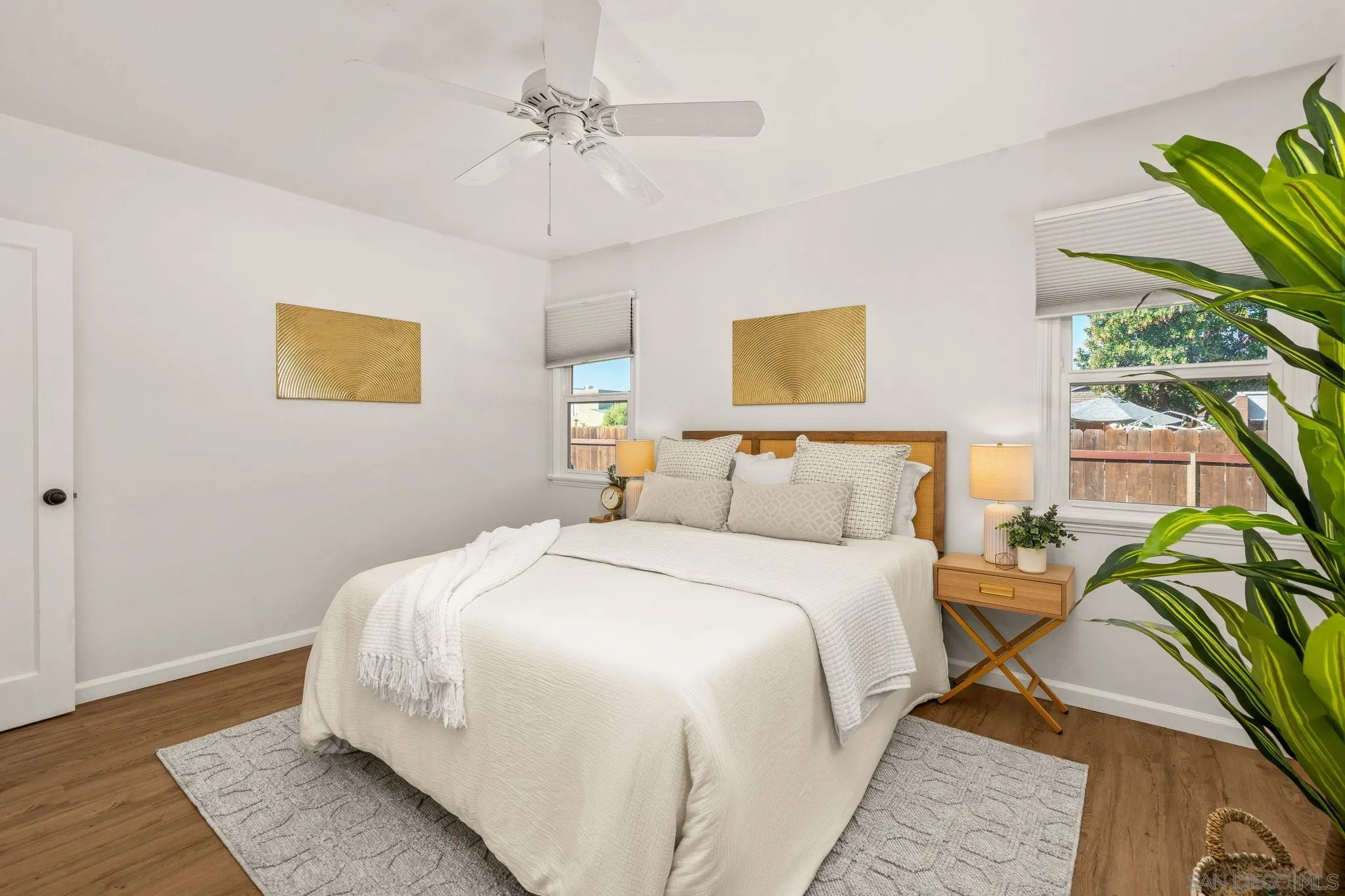 1395 Summit Avenue Cardiff, CA 92007 - Photo 22 of 47 a bedroom with a bed lamp and a potted plant