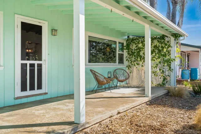 a view of a house with a yard and plant