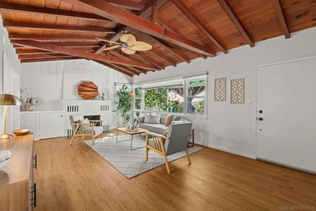 a living room with furniture and wooden floors