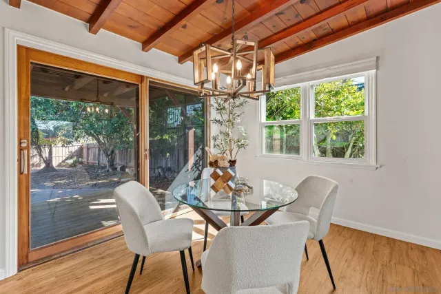 a view of a dining room with furniture large windows and wooden floor