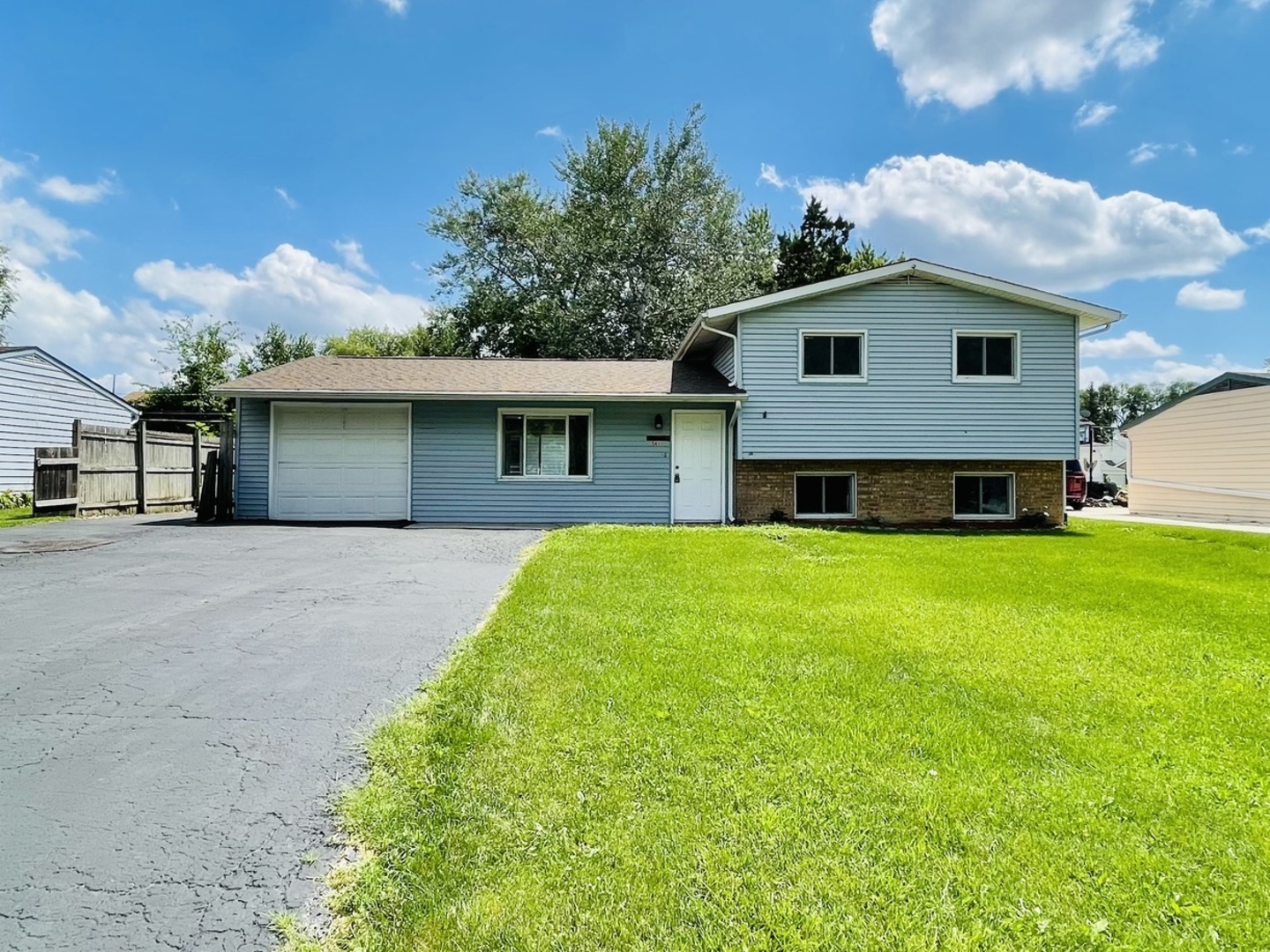 a front view of house with yard and green space